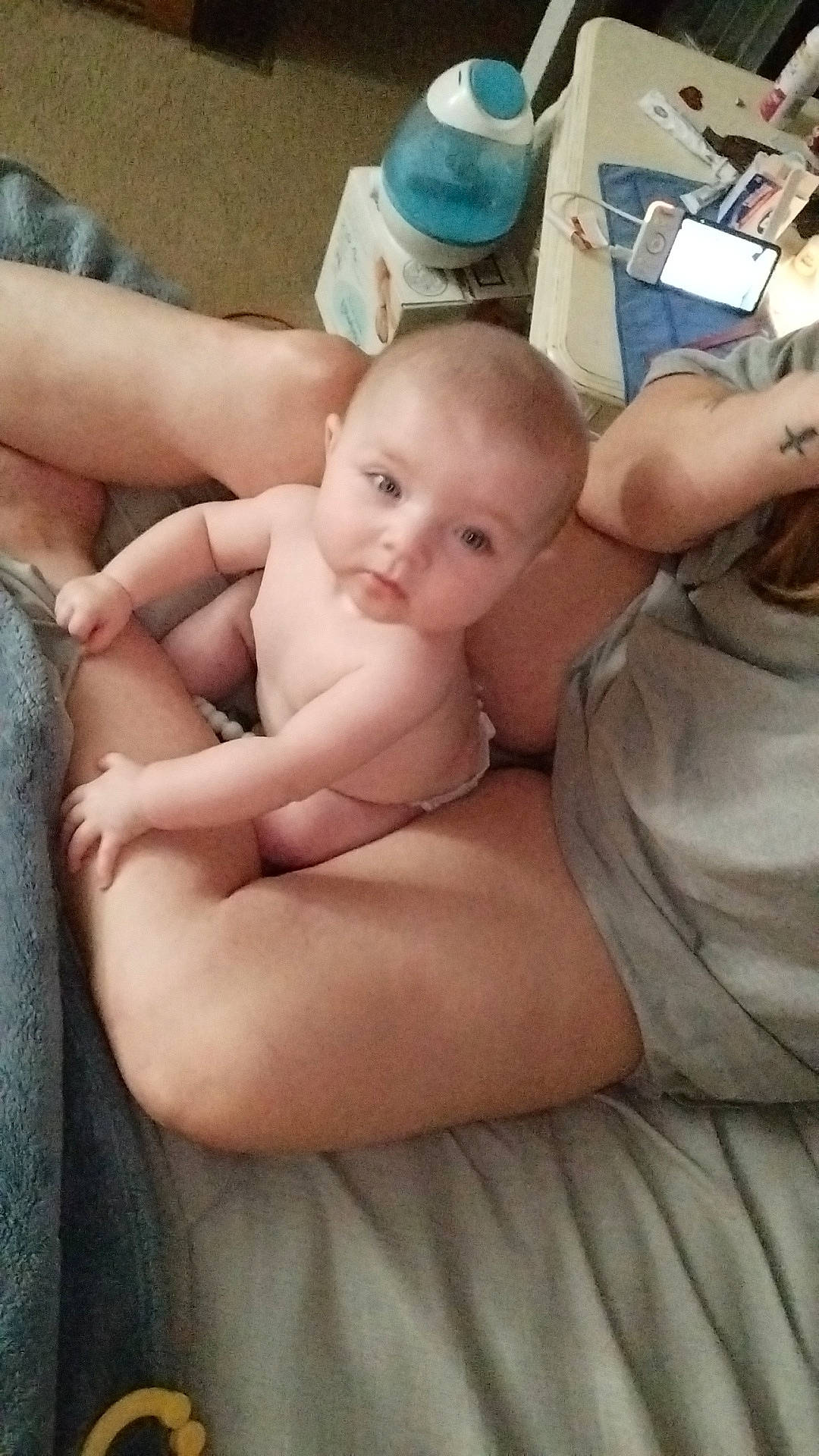 Dani is registered to the contest to win money with this photo: abdomen, arm, baby, barechested, barefoot, cheek, chest, comfort, finger, hand, human_body, joint, mouth, person, shoulder, skin, stomach, thigh, thumb, toddler
