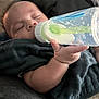baby, bottle, milk, sleeping, hand, blanket, infant, feeding, child, cozy, peaceful, indoors, closeup, person, cute, young, resting, soft_light, nap, comfort