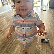 Adrian joined the competition — help win amazing prizes! toddler, child, smiling, curly_hair, striped_shirt, barefoot, indoor, wooden_floor, shoe, dog, sliding_door, sunlight, living_room, happy, person, young_child, casual_clothing, home, playful, cute