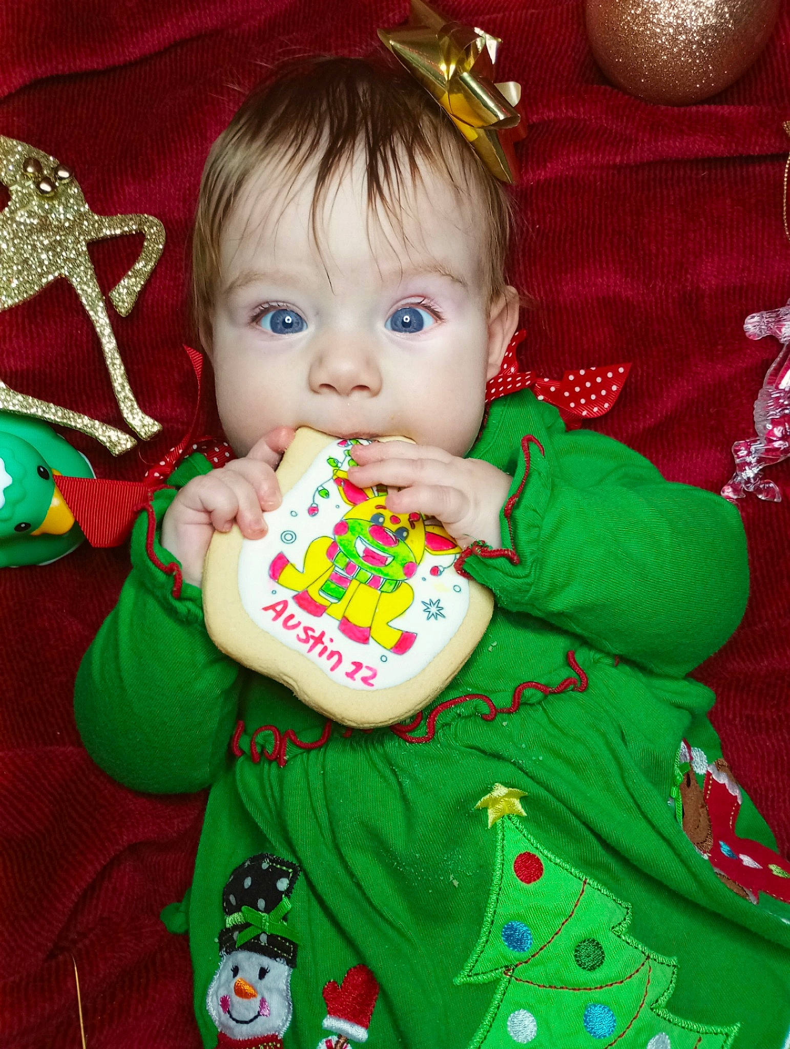 Austin joined the competition — help win amazing prizes! baby, baby_toddler_clothing, cheek, child, christmas, christmas_eve, christmas_ornament, event, facial_expression, fashion_accessory, fictional_character, green, happy, hat, holiday, person, play, red, sleeve, sweetness