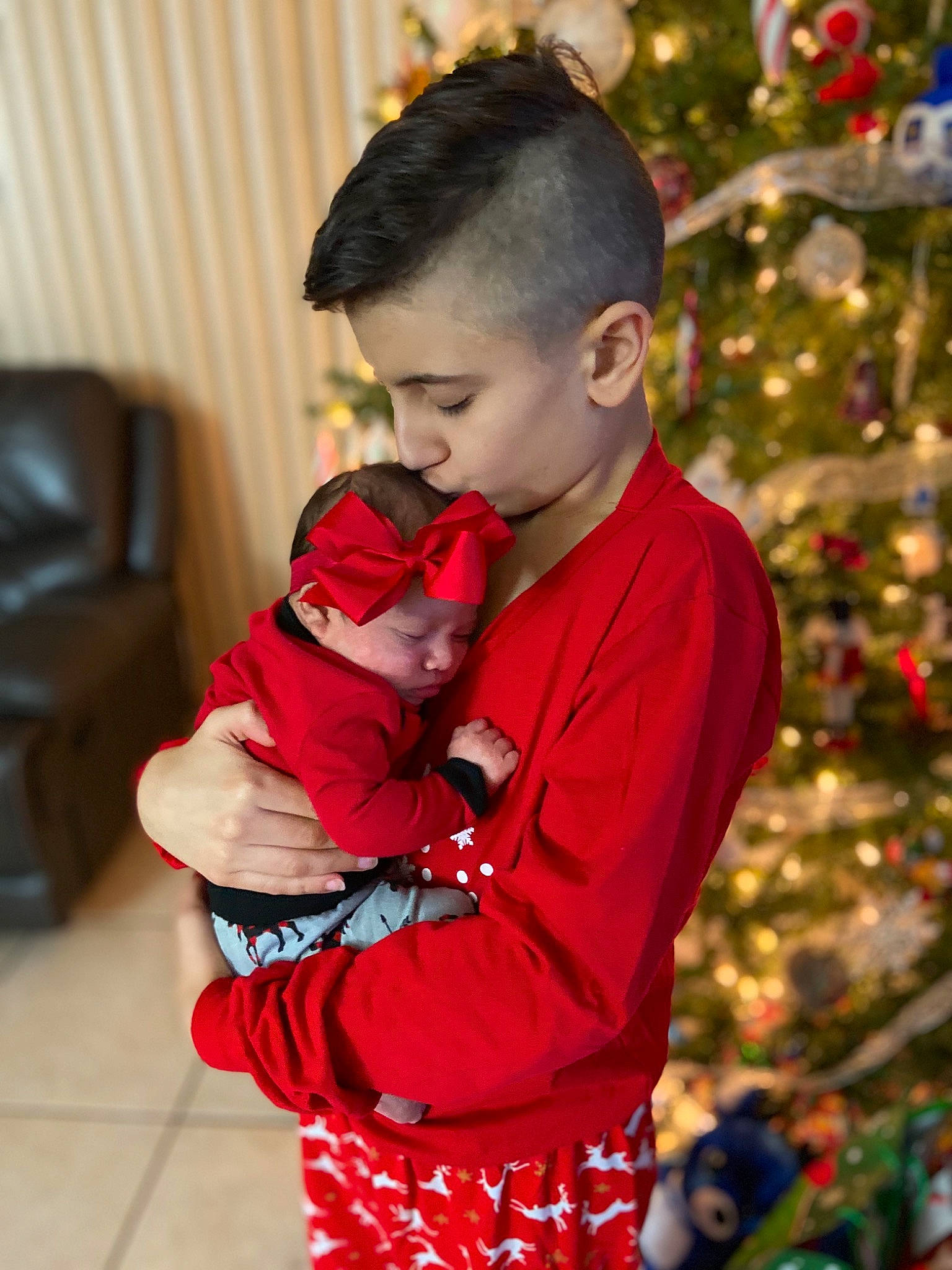 Harmonee is registered to the contest to win money with this photo: baby, child, christmas, christmas_eve, christmas_ornament, costume, event, fictional_character, headwear, holiday, outerwear, person, plant, red, toddler, tradition, tree