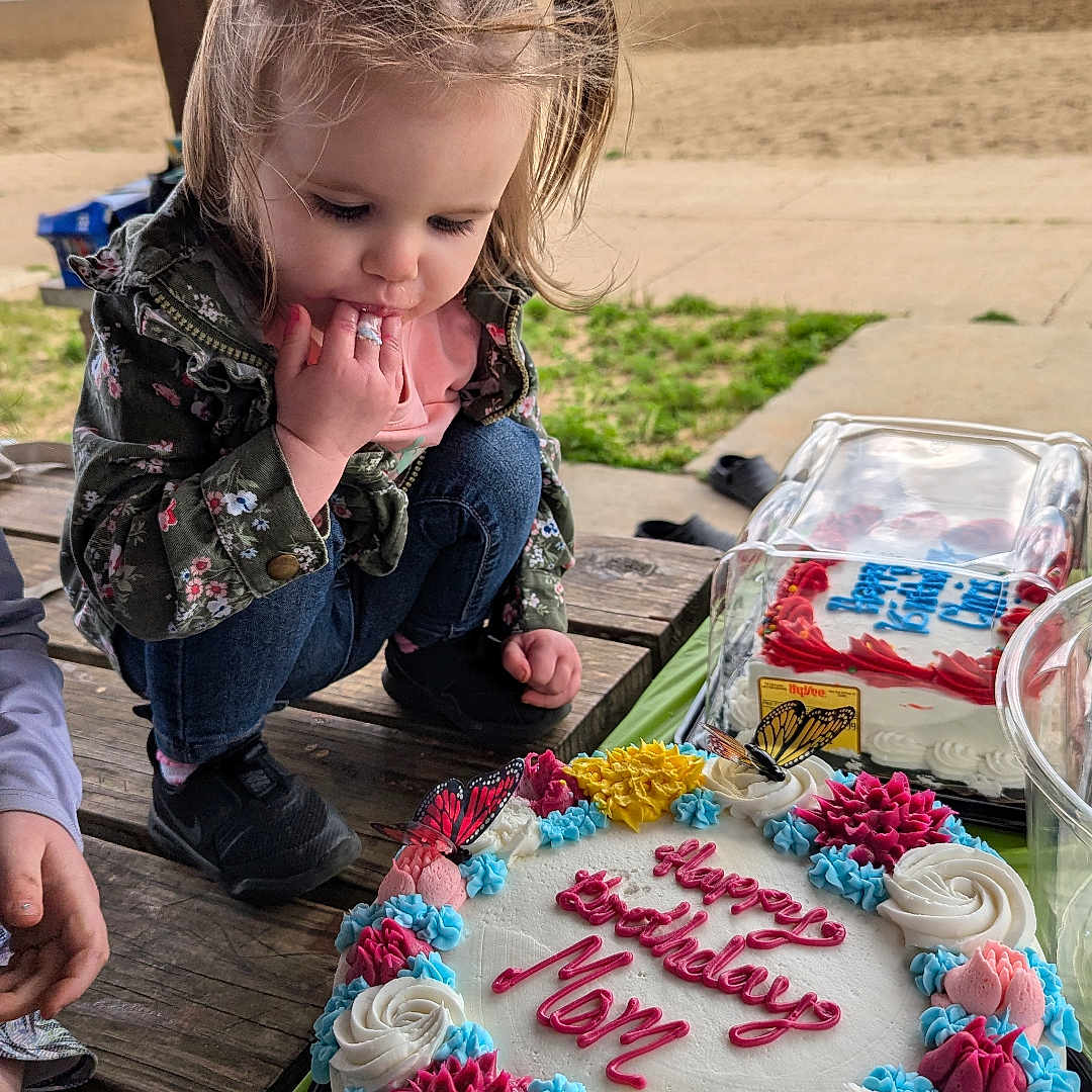 Anna joined the competition — help win amazing prizes! birthday_cake, butterflies, celebration, child, colorful, curly_hair, dessert, flowers, food, hand, jacket, jeans, lake, nature, outdoor, park, picnic_table, sand, sky, toddler