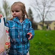 Anna joined the competition — help win amazing prizes! background_blur, blue_jacket, casual_clothing, child, cloudy, curious, daytime, girl, grass, holding, nature, outdoor, person, pink_skirt, plastic_bag, portrait, standing, trees, weather, young_child