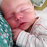 Eleonore participe au concours pour gagner de l'argent avec cette photo : baby, newborn, sleeping, infant, closeup, face, hand, clothing, striped, fabric, soft, peaceful, cuddle, portrait, skin, cute, child, rest, comfort, indoors