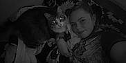 Chesterfield joined the competition — help win amazing prizes! person, cat, selfie, indoor, blanket, lying_down, pet, animal, face, portrait, cozy, feline, companion, resting, dark, monochrome, cute, closeup, casual, relax
