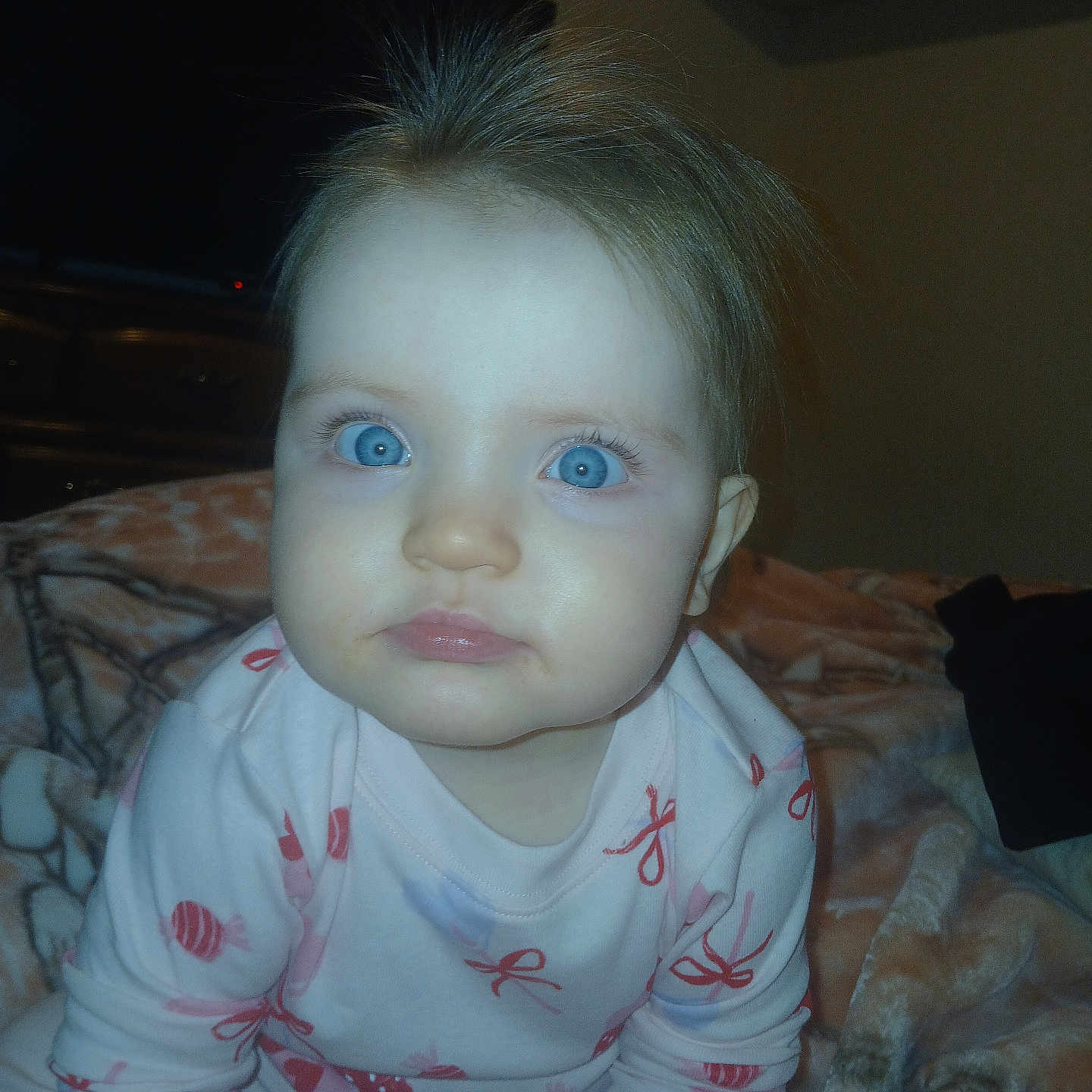 Londyn joined the competition — help win amazing prizes! baby, child, blue_eyes, pajamas, blanket, bedroom, indoor, face, person, hair, cute, infant, sitting, expression, soft_lighting, cozy, young, curious, clothing, portrait