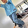 Zakari is registered to the contest to win money with this photo: child, smiling, indoor, blue_shirt, denim_pants, socks, carpet, living_room, window, baby_stroller, playful, happy, person, pose, casual_clothing, home, daylight, young_child, missing_tooth, joyful