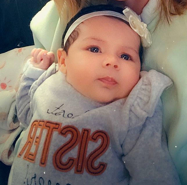 Sydney is registered to the contest to win money with this photo: baby, baby_toddler_clothing, cheek, chin, cool, ear, eyebrow, eyelash, face, forehead, happy, headwear, iris, lip, mouth, nose, organ, person, pink, skin