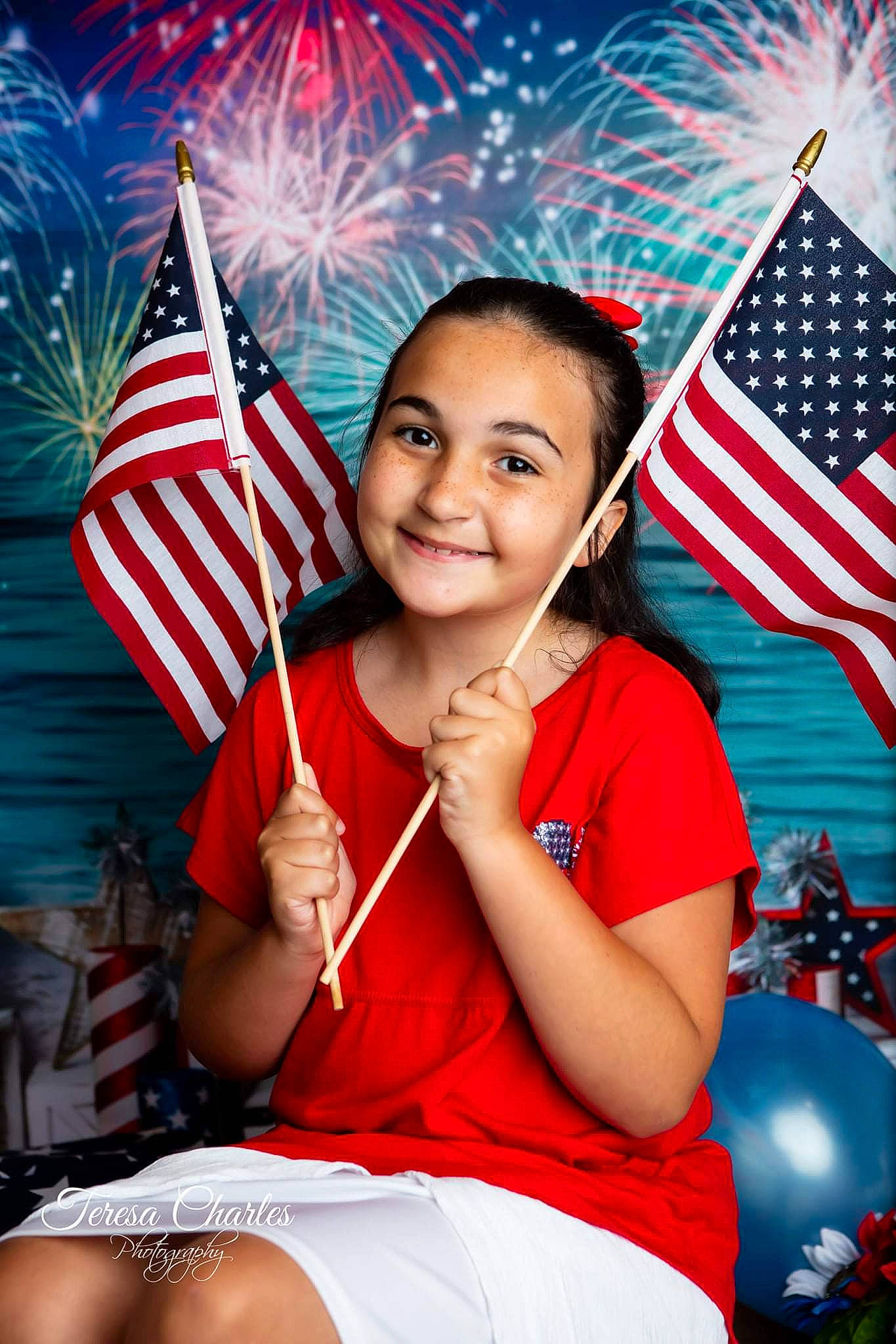 Ashton is registered to the contest to win money with this photo: balloon, blue, child, electric_blue, event, flag, flag_day_usa, flag_of_the_united_states, fun, happy, holiday, human_leg, joy, leisure, party_supply, person, portrait_photography, red, sitting, smile
