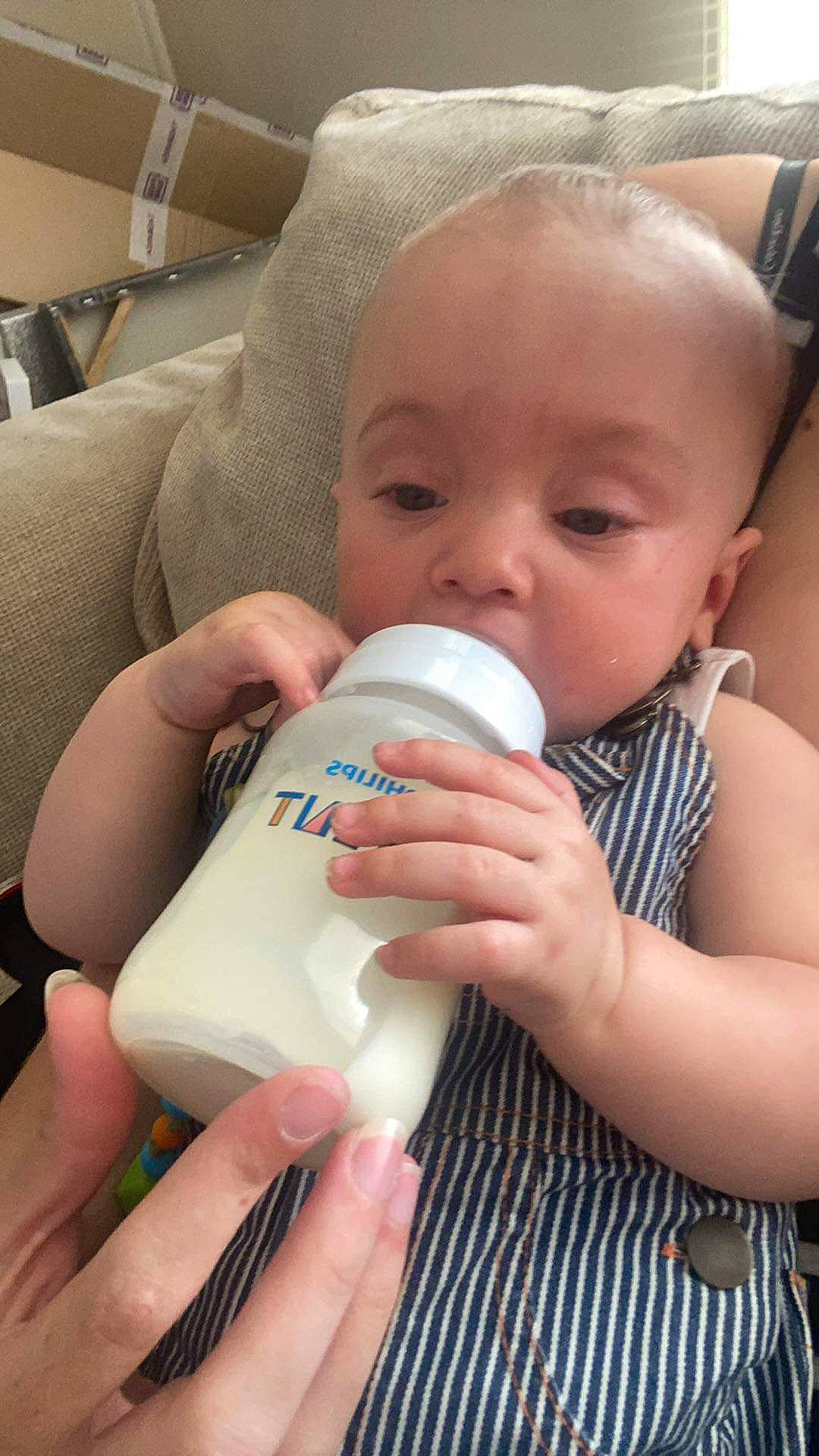 Ali joined the competition — help win amazing prizes! baby, baby_bottle, baby_bottle_feeding, bottle, cheek, drinkware, ear, eyebrow, eyelash, finger, gesture, hand, mouth, nail, neck, nose, person, plastic_bottle, product, skin