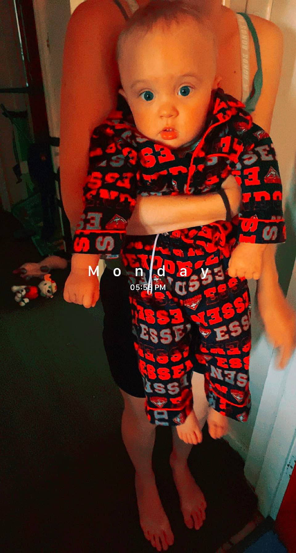 Ali is registered to the contest to win money with this photo: baby, baby_toddler_clothing, child, fun, head, human_leg, joint, leg, one_piece_garment, orange, pattern, person, plaid, skin, sleeve, standing, surprise, tartan, thigh, toddler