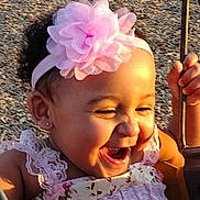 Eliana is registered to the contest to win money with this photo: toddler, child, smiling, laughing, flower_headband, pink, dress, swing, playground, sunlight, happy, outdoor, holding, hand, face, cute, baby, girl, joyful, summer