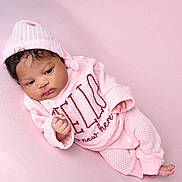Aliana joined the competition — help win amazing prizes! baby, infant, pink_clothing, knit_hat, knit_sweater, knit_pants, soft_texture, pastel_background, newborn, resting, portrait, cute, child, lying_down, indoors, warm, cozy, peaceful, face, hand