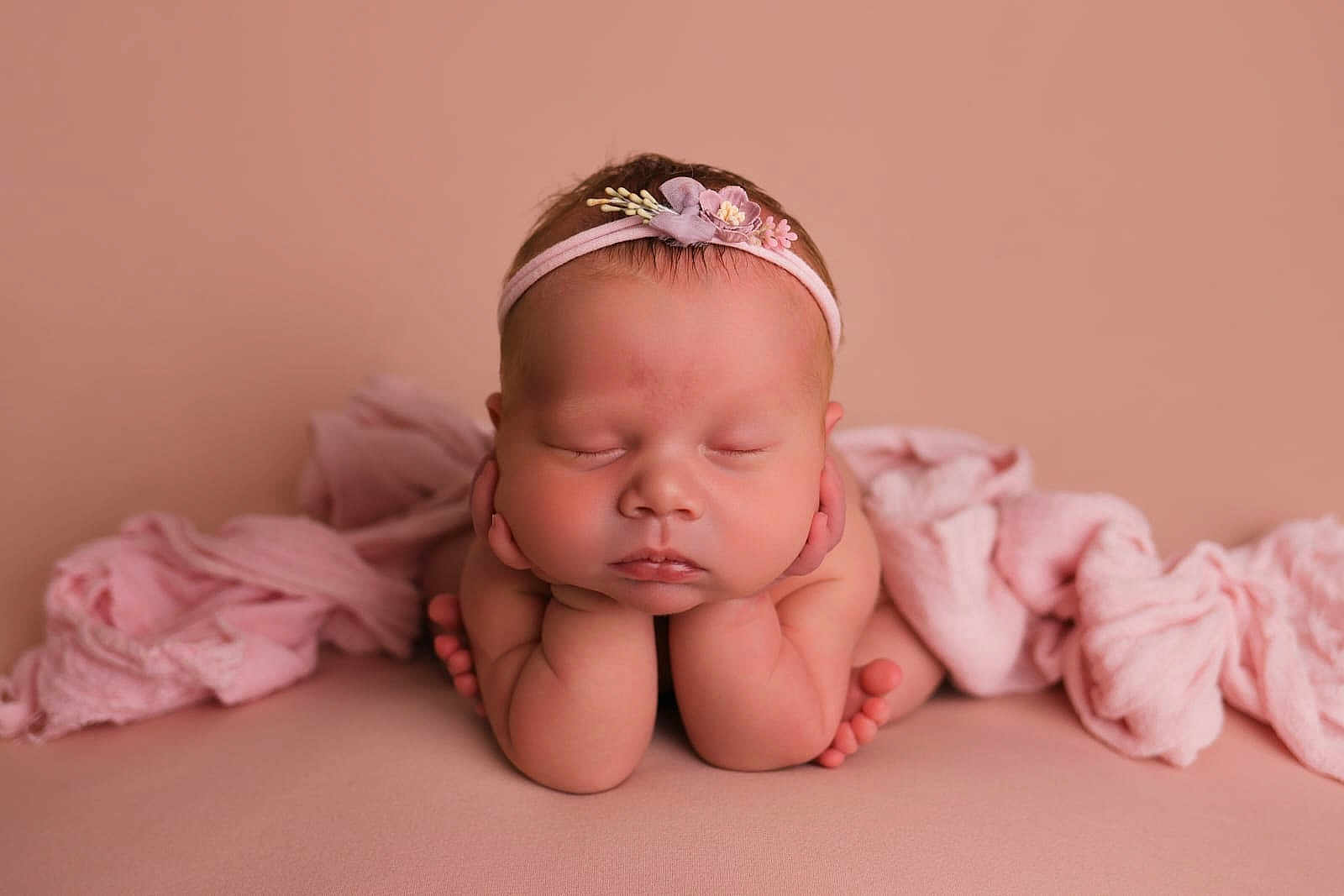 Ruby is registered to the contest to win money with this photo: baby, sleeping, headband, pink, newborn, infant, hands, feet, soft_fabric, portrait, cute, peaceful, child, closeup, studio, adorable, resting, skin, flower, tender