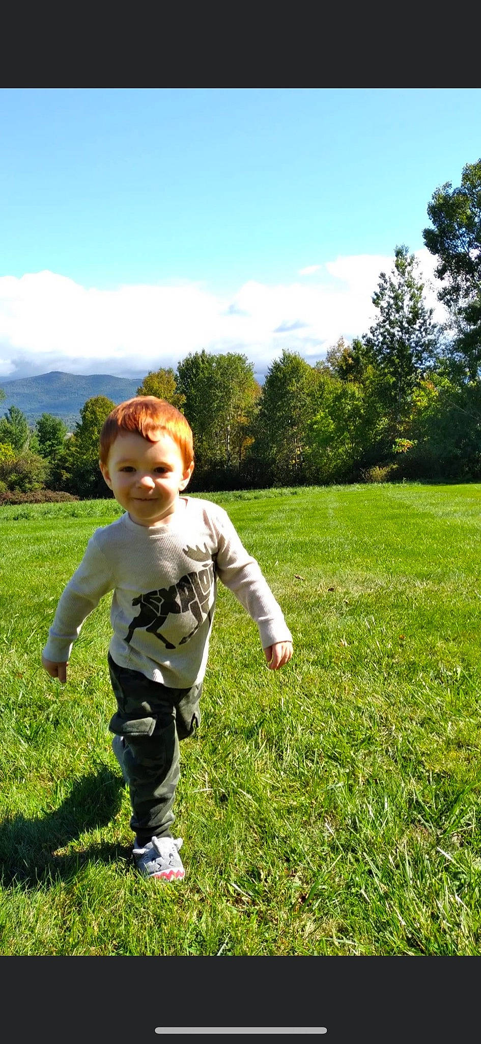 Greyson joined the competition — help win amazing prizes! baby_toddler_clothing, cloud, grass, grassland, green, happy, joy, landscape, leaf, leisure, meadow, natural_landscape, people_in_nature, person, plant, prairie, sky, smile, summer, t_shirt