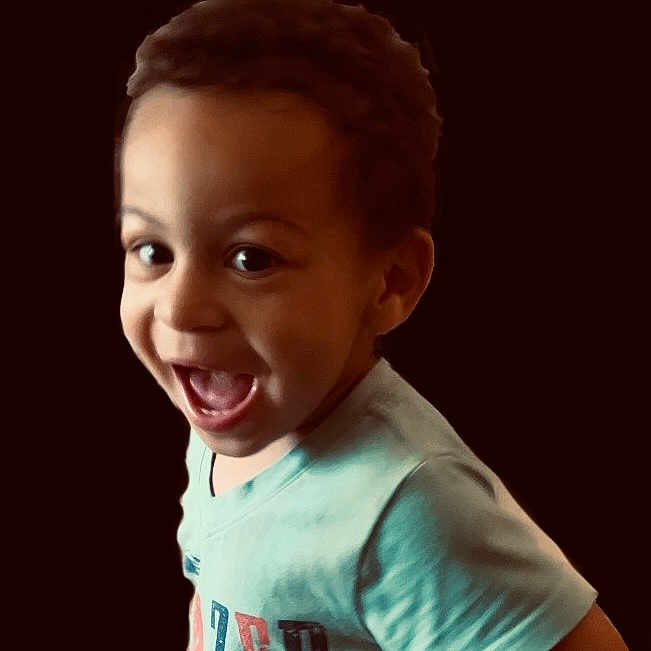 Ephraim is registered to the contest to win money with this photo: accessories, baby, babylaughing, bodypart, clothing, earring, face, hair, happy, head, jewelry, laughing, mouth, person, photography, portrait, shirt, smile, t_shirt, teeth