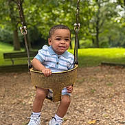 Tyler Ramirez joined the competition — help win amazing prizes! toddler, child, swing, playground, park, outdoor, smiling, happy, trees, bench, grass, shoes, clothing, woodchips, summer, recreation, cute, person, young, fun
