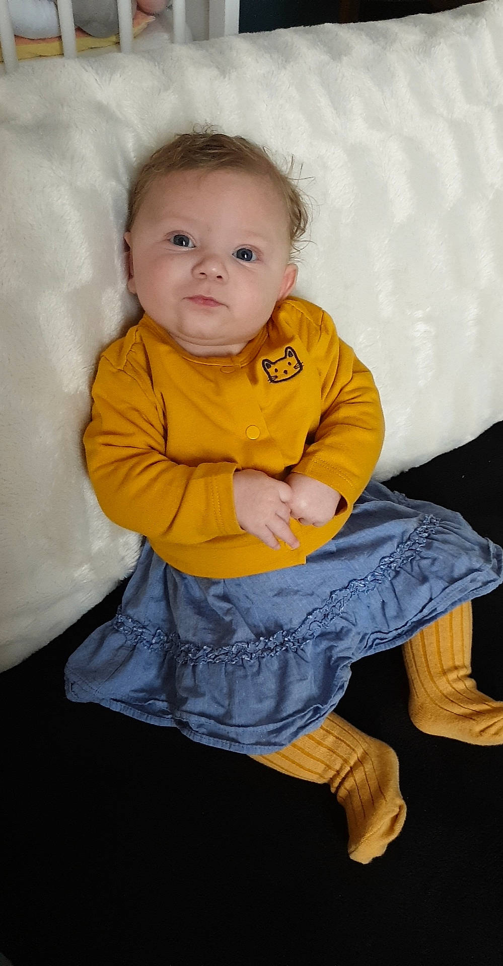 Ylona participe au concours pour gagner de l'argent avec cette photo : baby, baby_toddler_clothing, cheek, child, comfort, dress, eye, flooring, fun, hand, happy, human_body, human_leg, iris, linens, pattern, person, sitting, skin, sleeve