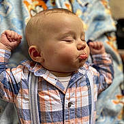 Julius joined the competition — help win amazing prizes! baby, blanket, cheeks, child, closeup, clothing, cute, expression, face, hands_up, indoors, infant, person, plaid_shirt, portrait, resting, sleeping, soft_light, suspenders, young_child
