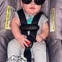 Julius joined the competition — help win amazing prizes! baby, car_seat, casual_clothing, child, clip, cute, dinosaur_print, funny, indoor, infant, onesie, pacifier, portrait, relaxed, safety_harness, seat, smiling, straps, sunglasses, young_child