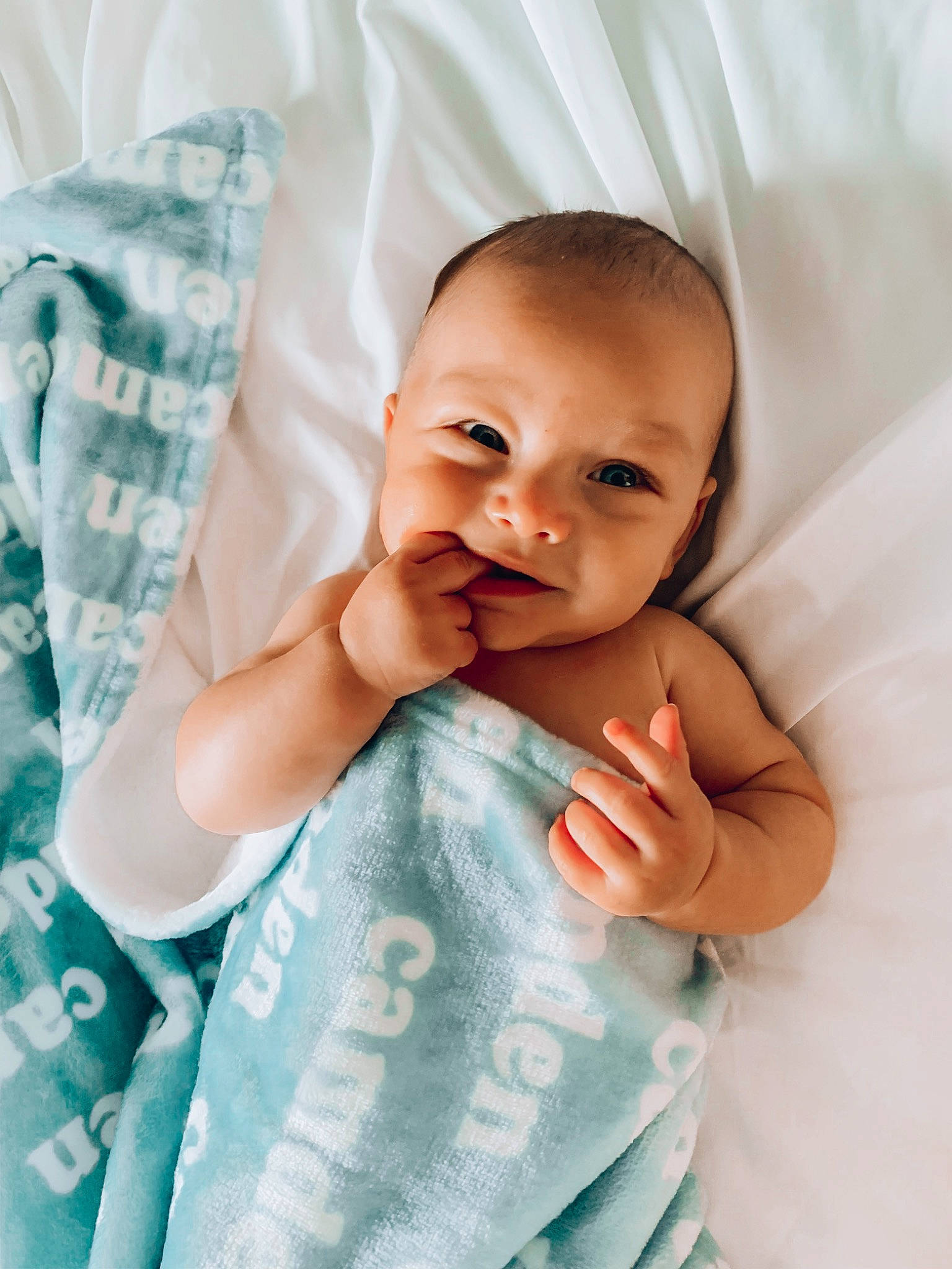 Camden is registered to the contest to win money with this photo: arm, azure, baby_toddler_clothing, cheek, collar, comfort, eyebrow, finger, gesture, hand, happy, iris, lip, nose, organ, person, product, skin, sleeve, smile