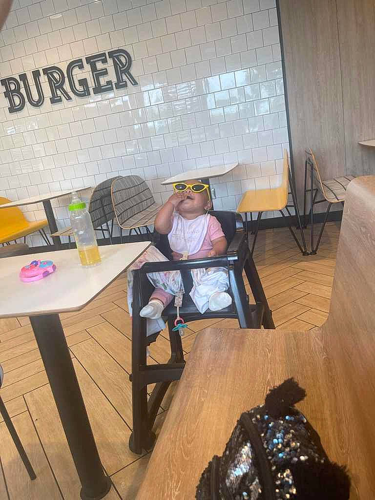 Lilliana joined the competition — help win amazing prizes! art, backpack, bag, chair, coffee_table, eyewear, fashion_accessory, floor, flooring, hardwood, hat, interior_design, luggage_and_bags, person, room, sitting, sun_hat, table, visual_arts, wood