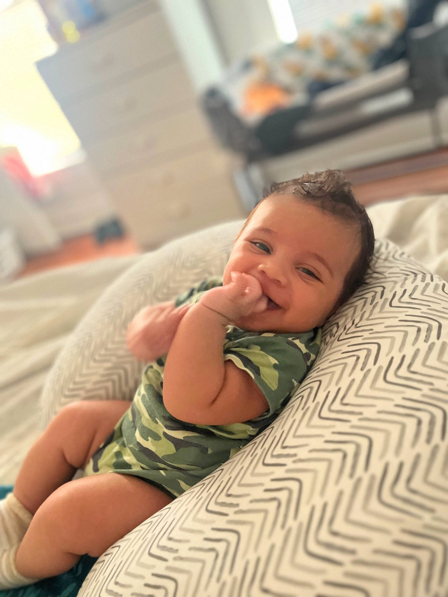 Enzo is registered to the contest to win money with this photo: baby, baby_toddler_clothing, bedding, cheek, child, comfort, eye, flooring, fun, happy, human_body, linens, pattern, person, room, sitting, skin, smile, toddler, vacation
