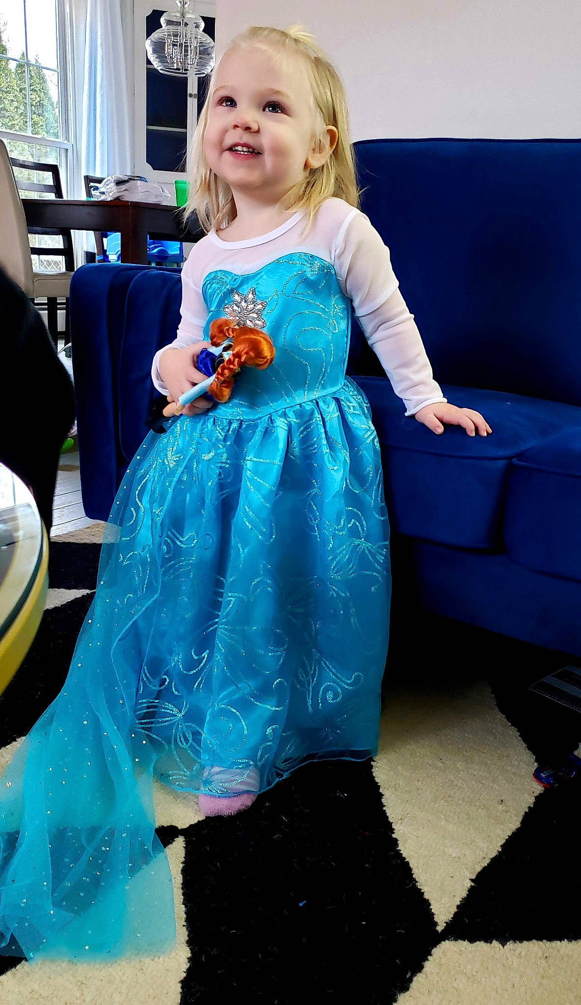 Violette is registered to the contest to win money with this photo: blue, child, clothing, costume, dress, electric_blue, fashion_design, formal_wear, person, sitting, sleeve, textile, toddler, turquoise