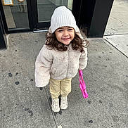 Aura joined the competition — help win amazing prizes! building, child, coat, cute, daytime, door, glass, happy, hat, outdoor, pants, person, pink_purse, reflection, sidewalk, smile, sneakers, urban, winter_clothing, young