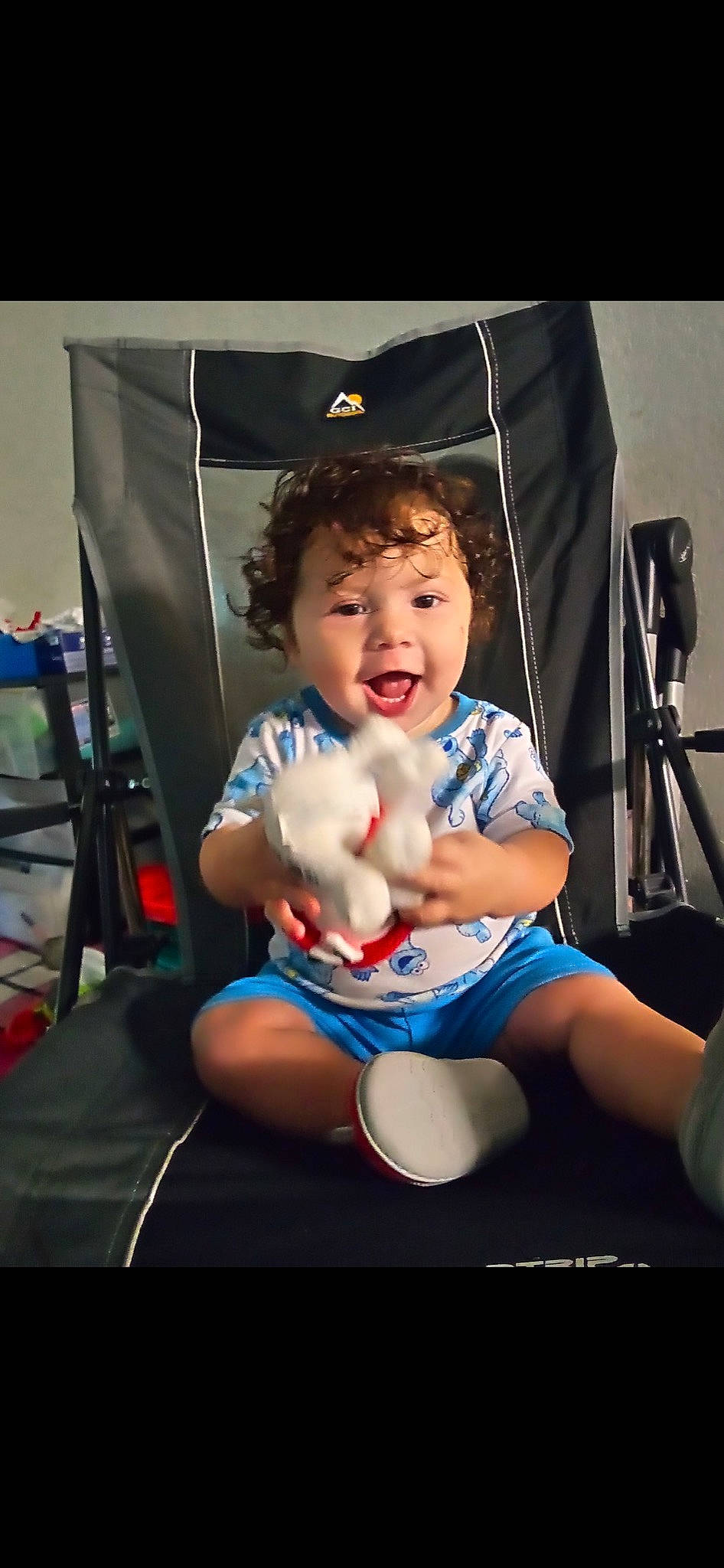 Jose is registered to the contest to win money with this photo: baby, baby_carriage, baby_products, chair, child, electric_blue, event, flash_photography, folding_chair, fun, happy, human_leg, lap, leisure, person, recreation, room, sitting, smile, toddler