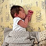 Bonnie joined the competition — help win amazing prizes! baby, blanket, cartoon_pattern, child, cozy, cute, face, hair, indoors, infant, knitted_blanket, newborn, peaceful, resting, side_profile, sleeping, small_hands, soft_lighting, white_onesie, yellow_sheet