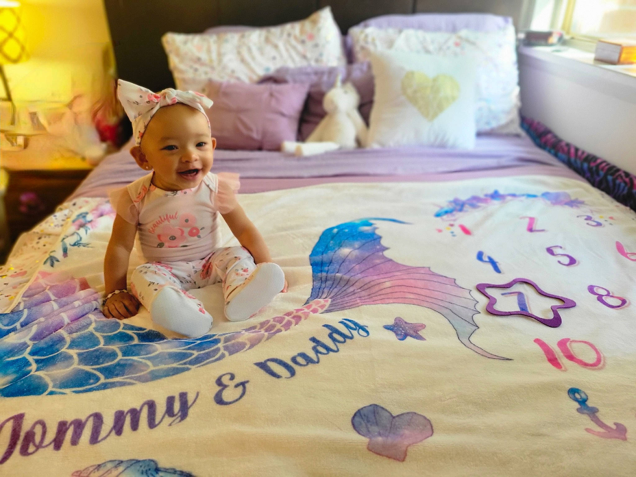 Demi joined the competition — help win amazing prizes! baby, baby_toddler_clothing, bed, bed_sheet, bedding, comfort, flooring, font, happy, hardwood, joy, lamp, linens, pattern, person, pillow, smile, t_shirt, textile, toddler