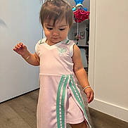 Arya joined the competition — help win amazing prizes! balloons, barefoot, bow, bracelet, celebration, child, cute, dress, floor, home, indoor, looking_down, person, pink_dress, pony_tail, portrait, standing, toddler, wooden_floor, young_child