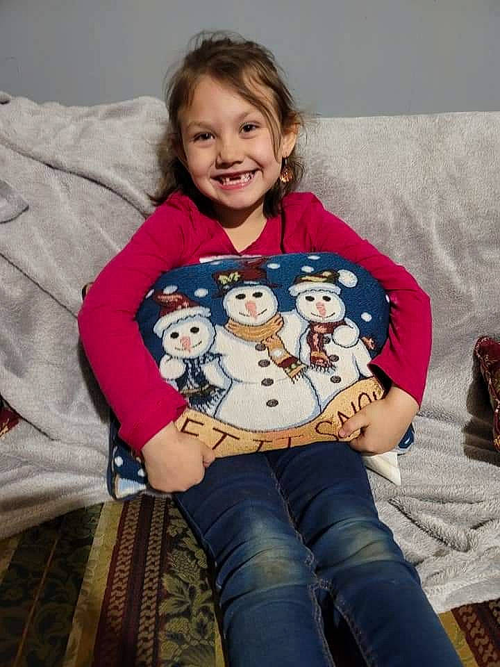 Sofia is registered to the contest to win money with this photo: baby_toddler_clothing, child, comfort, couch, facial_expression, fun, hairstyle, happy, head, jeans, joy, lap, linens, person, sitting, sleeve, smile, t_shirt, thigh, throw_pillow