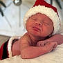Julia joined the competition — help win amazing prizes! baby, newborn, infant, santa_hat, christmas, holiday, sleeping, portrait, cute, festive, blanket, bokeh, ornament, hand, skin, closeup, cozy, soft_focus, lying_down, hat