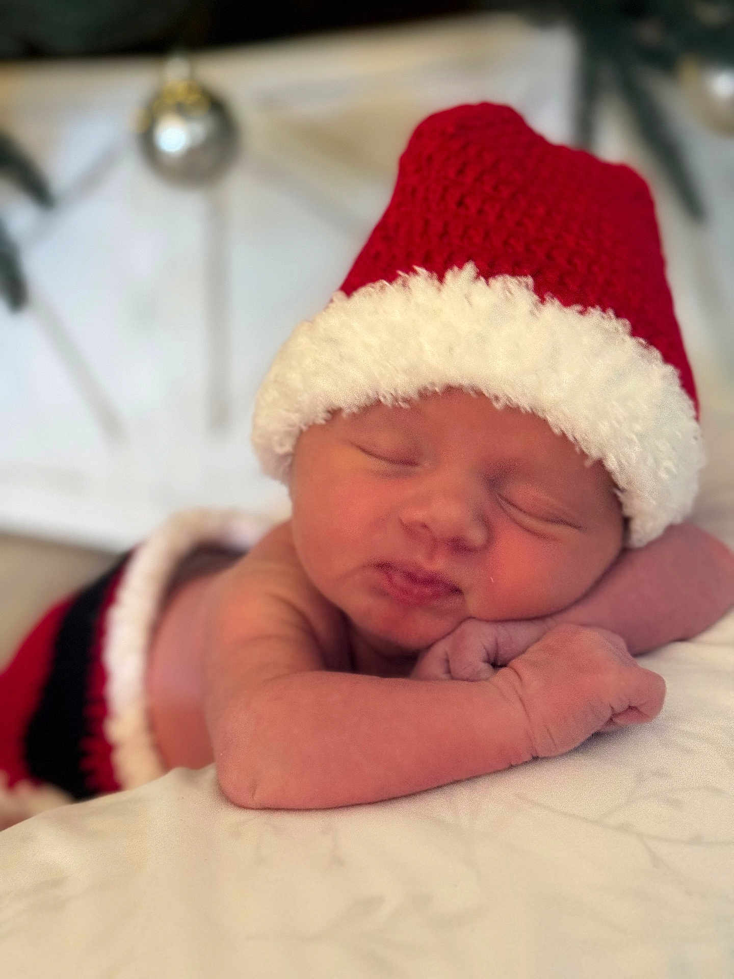 Julia joined the competition — help win amazing prizes! newborn, baby, sleeping, santa_hat, christmas, holiday, infant, blanket, soft_focus, portrait, hands, face, closed_eyes, cuteness, cozy, red_hat, bauble, decor, bedding, cute