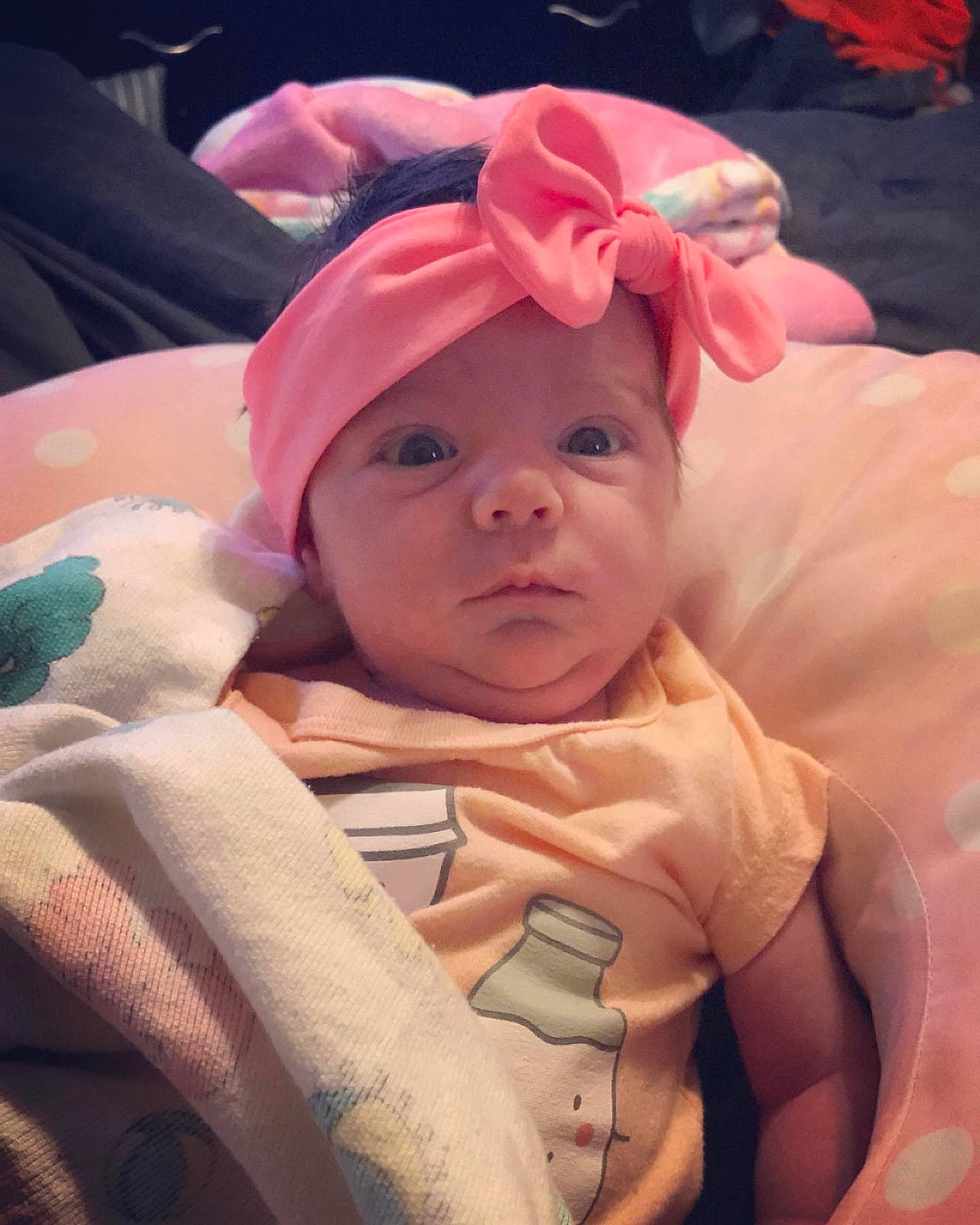 Olivia is registered to the contest to win money with this photo: baby, cheek, child, face, head, headgear, headwear, person, pink, skin, toddler