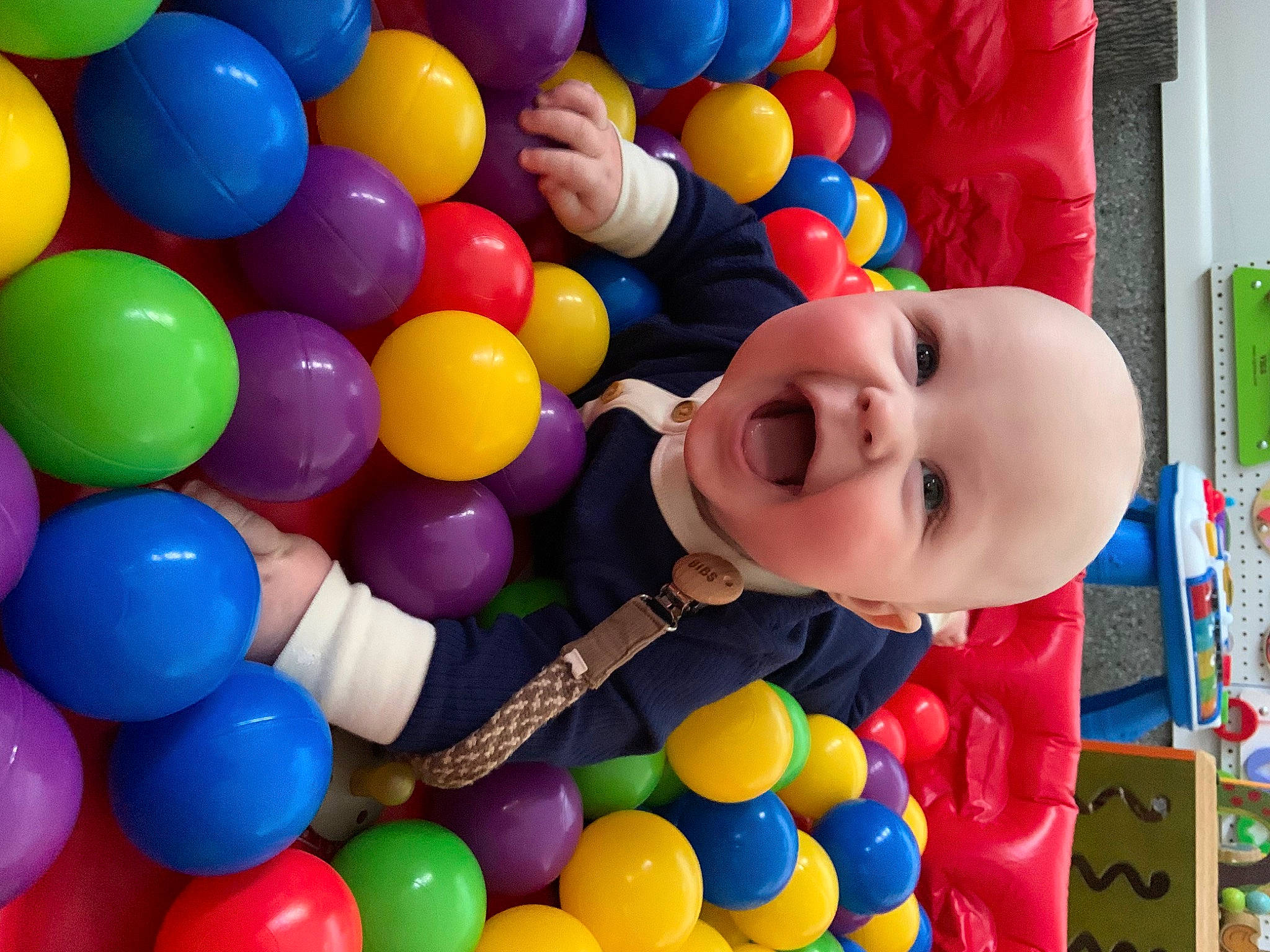 Lincoln is registered to the contest to win money with this photo: baby, baby_playing_with_toys, ball_pit, balloon, child, fun, happy, human_settlement, leisure, party_supply, people, person, photograph, play, playground, product, recreation, smile, snapshot, toddler