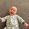 baby, infant, child, smiling, happy, portrait, lying_down, carpet, indoor, onesie, pajamas, animal_print, clothing, face, eyes, mouth, hands, playful, home, photography