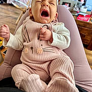 Pippa Elsie joined the competition — help win amazing prizes! baby, infant, yawning, pink_outfit, bunny_design, legs, indoor, home, cozy, furniture, wooden_floor, blurred_background, person, cute, child, soft_lighting, clothing, sitting, hands, face