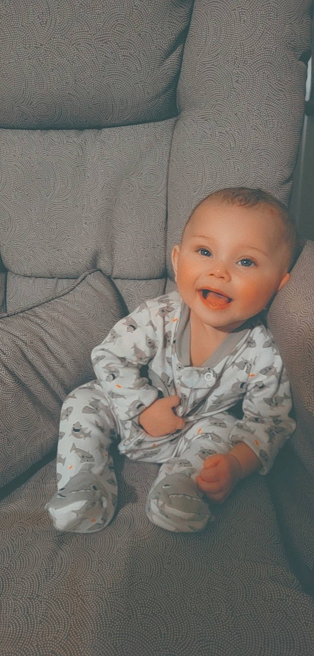 Joel joined the competition — help win amazing prizes! baby, baby_toddler_clothing, cheek, child, chin, comfort, couch, eye, floor, flooring, iris, mouth, nose, person, room, skin, sleeve, smile, textile, toddler