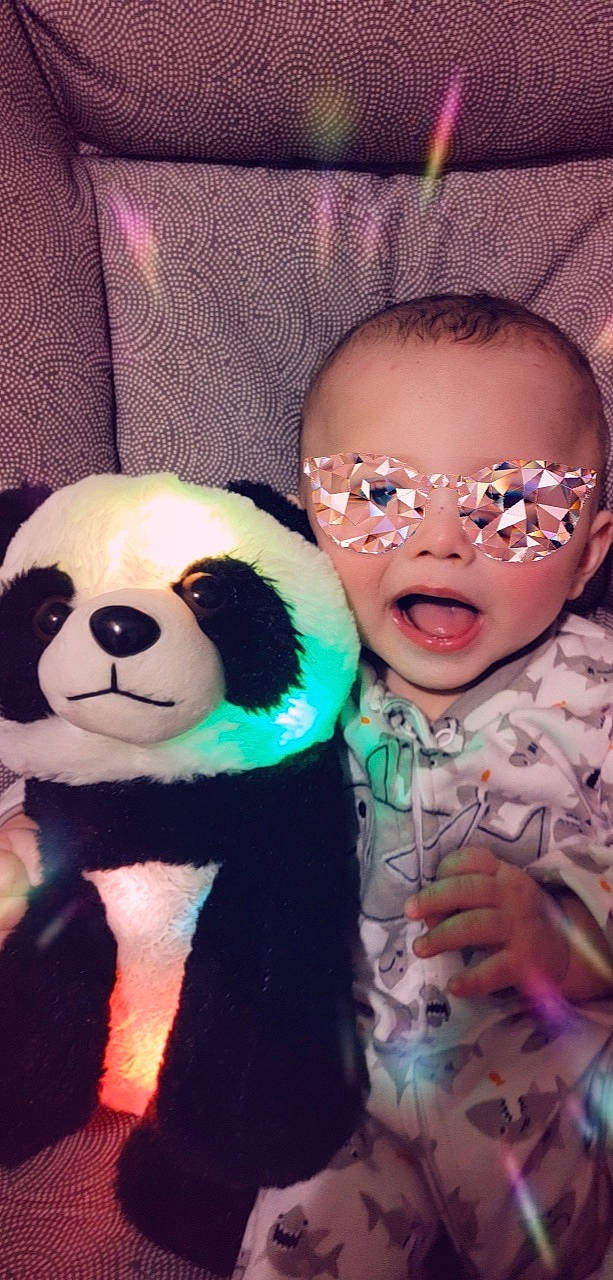 Joel joined the competition — help win amazing prizes! carnivore, child, companion_dog, cool, event, facial_expression, fun, happy, head, headgear, mammal, nose, organ, panda, person, pink, stuffed_toy, sunglasses, toddler, toy
