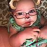 Galaxy Watts joined the competition — help win amazing prizes! baby, child, face_filter, glasses_filter, bear_ears, cute, infant, green_clothing, floral_pattern, diaper, lying_down, patterned_background, skin, arm, hand, closeup, portrait, indoors, person, playful