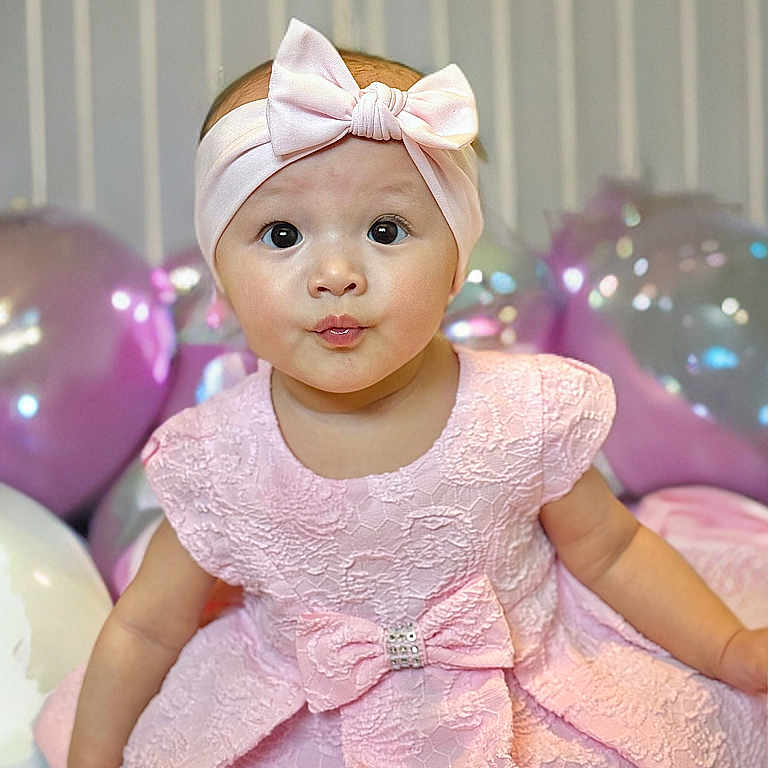 Zariah joined the competition — help win amazing prizes! accessories, baby, balloon, bodypart, clothing, couch, dress, eveningdress, face, finger, formalwear, furniture, hat, head, headband, person, photography, portrait, purple, toy