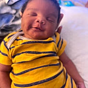 Joshua joined the competition — help win amazing prizes! baby, child, smiling, yellow_shirt, striped_clothing, portrait, infant, cute, resting, happy, person, face, hand, indoors, closeup, soft_focus, sleepy, young, toddler, content