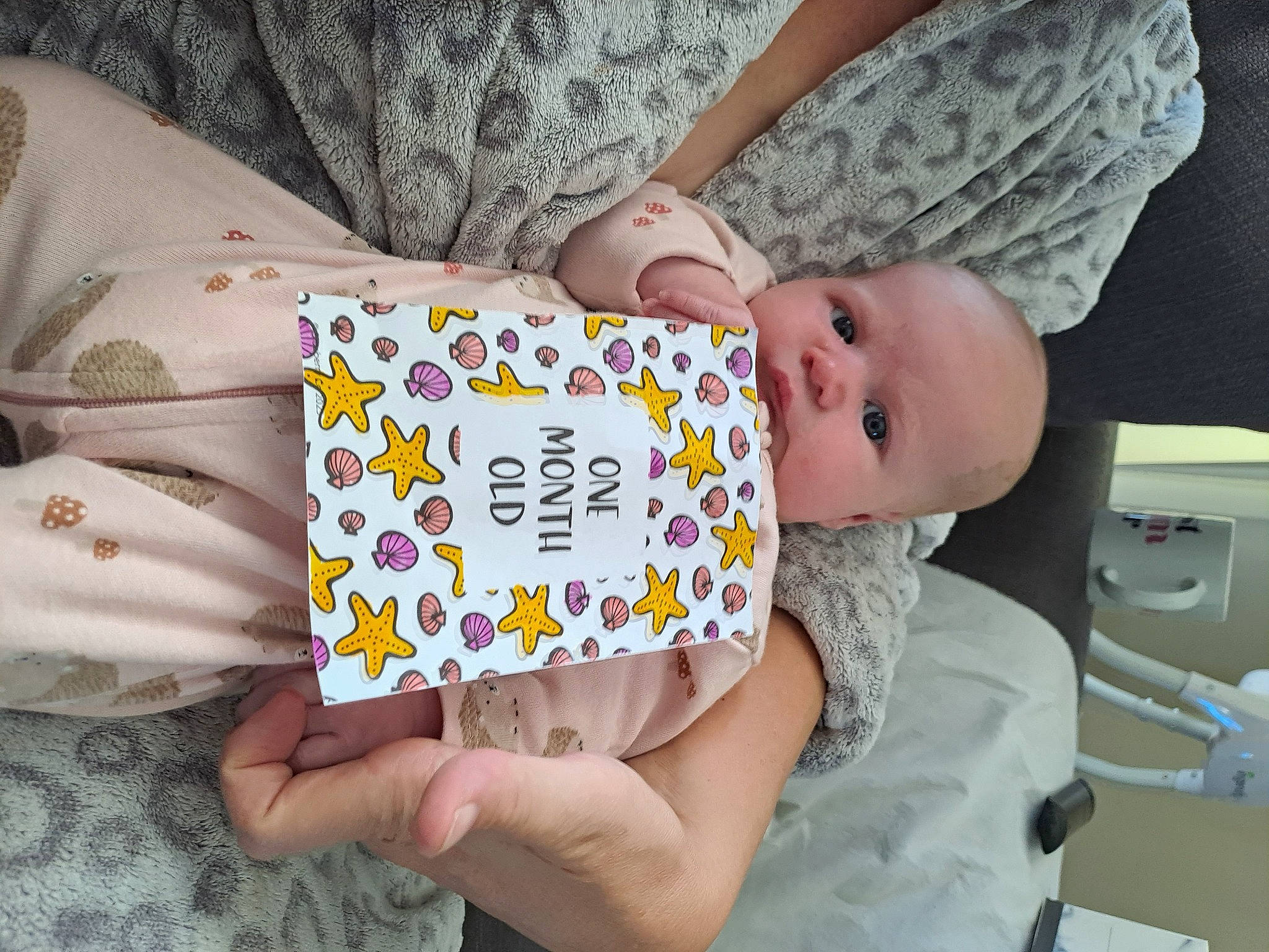 Imogen joined the competition — help win amazing prizes! baby, baby_products, baby_toddler_clothing, chair, child, comfort, finger, hand, happy, human_leg, linens, nail, pattern, person, room, sitting, sleeve, thigh, toddler