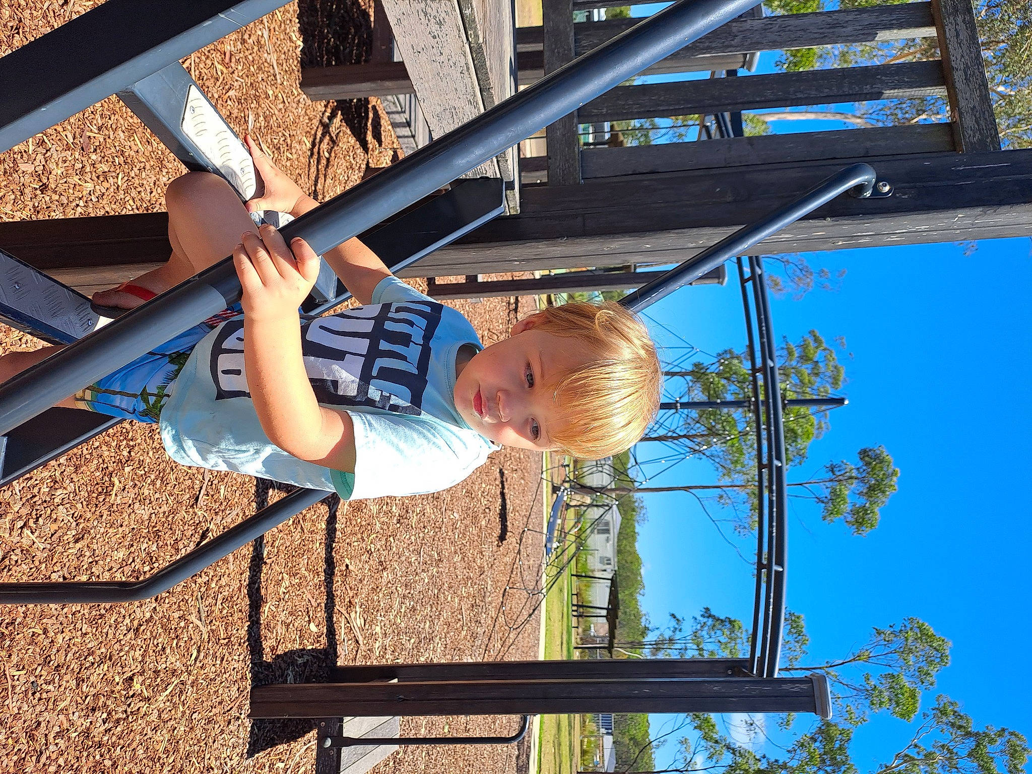 Owen joined the competition — help win amazing prizes! child, city, electric_blue, fun, leisure, metal, outdoor_play_equipment, person, play, playground, public_space, recreation, shade, sky, t_shirt, toddler, travel, tree
