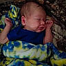 baby, newborn, sleeping, blanket, blue_clothing, cozy, infant, face, peaceful, resting, cute, soft_texture, hands, bedtime, portrait, child, indoors, warm, comfort, toddler