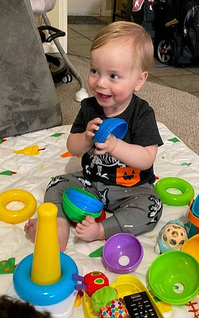 Mason is registered to the contest to win money with this photo: baby, baby_toys, chair, child, event, fun, joy, leisure, party_supply, people, person, plastic, play, product, recreation, smile, snapshot, t_shirt, table, toddler