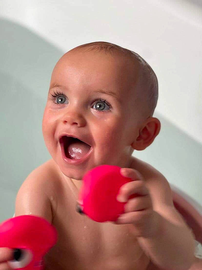 Esmè joined the competition — help win amazing prizes! arm, baby, cheek, ear, eye, eyelash, facial_expression, finger, gesture, hand, happy, human_body, lip, mouth, nose, person, pink, skin, thumb, tooth